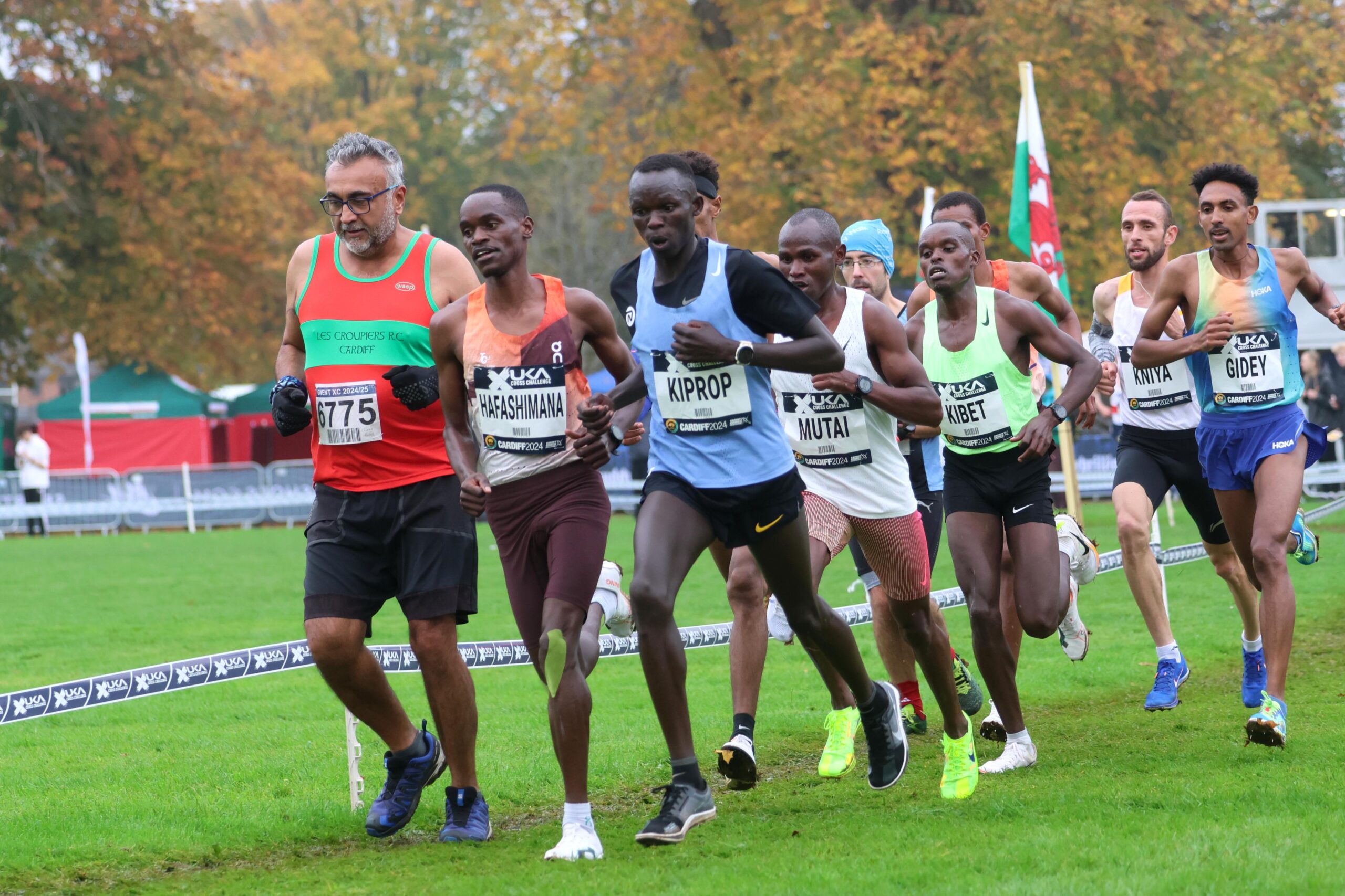 The elite race leaders overtaking a club runner at the Cardiff Cross Challenge.