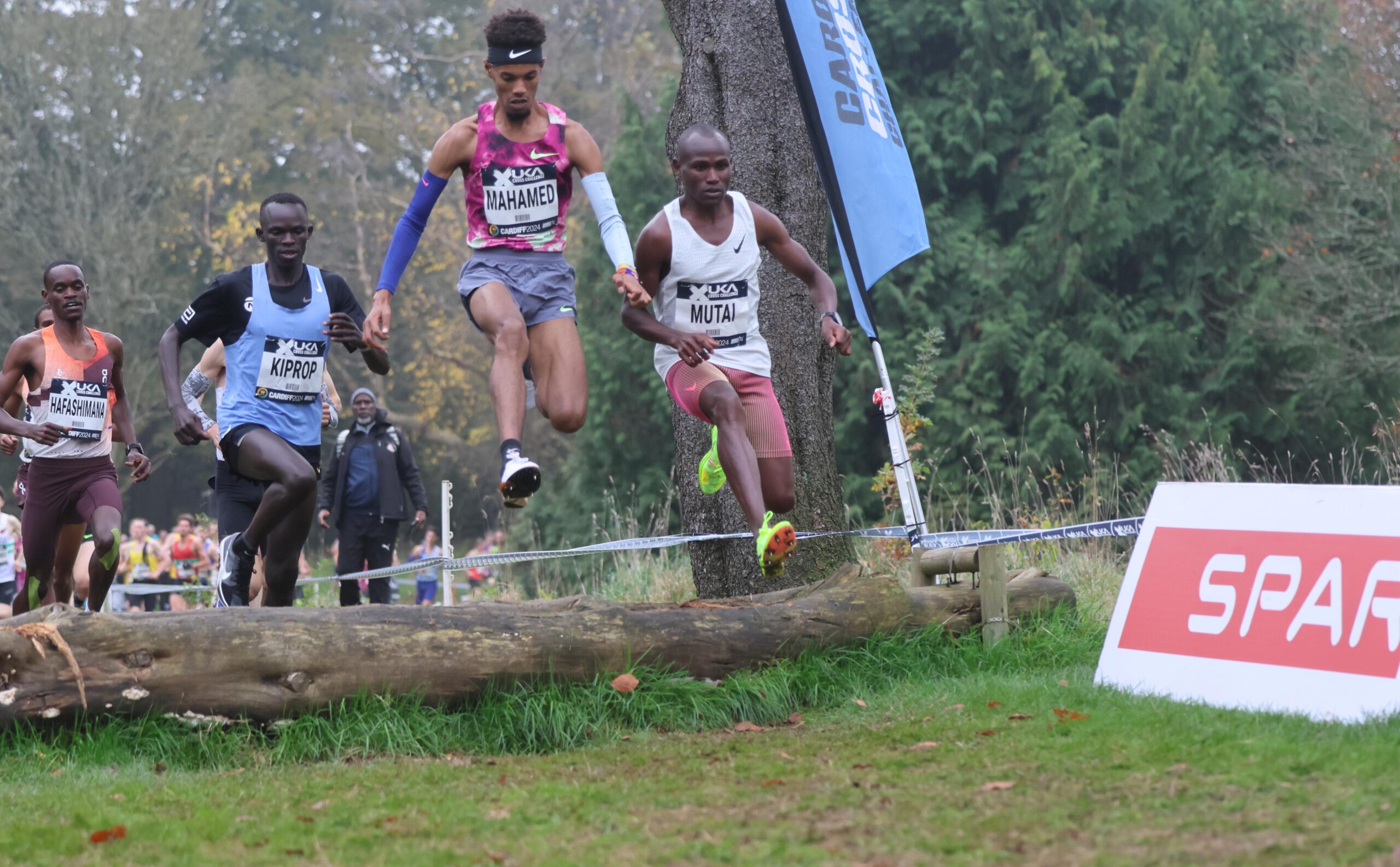 The leaders in the senior men's race negotiating the log jump.